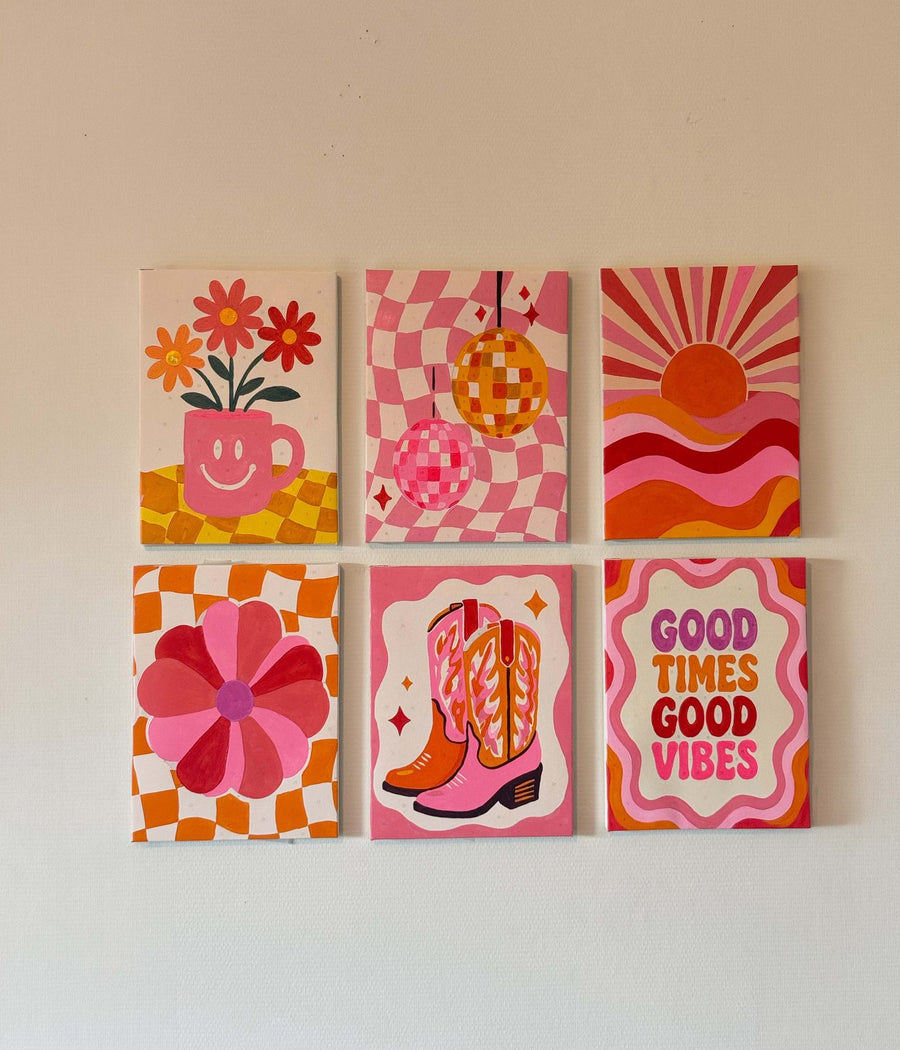 Six finished mini canvases hung together on a wall